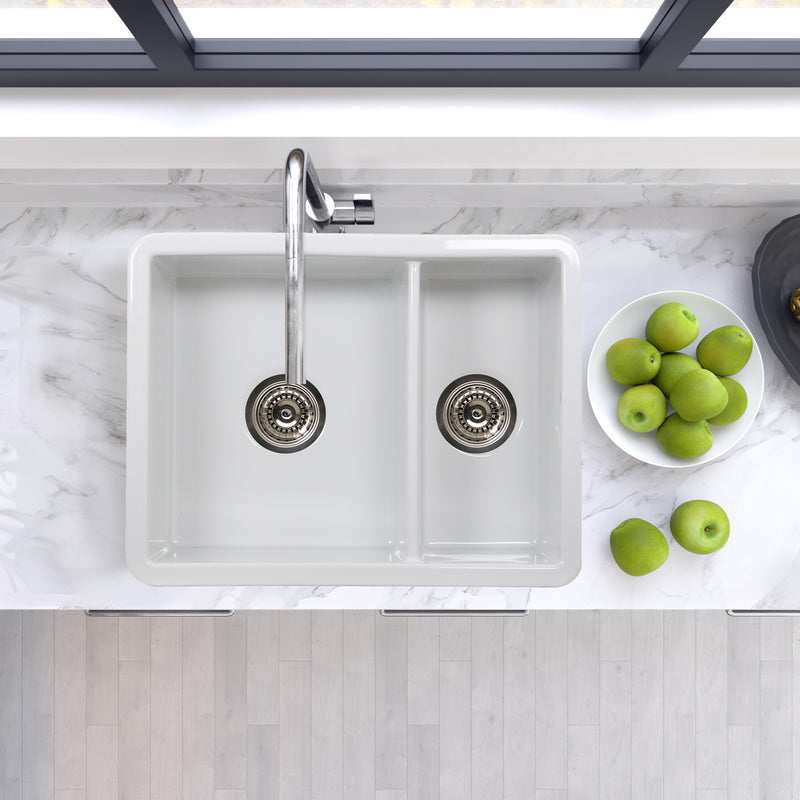 Nantucket Sinks ISFC24x18W-DB2 67/33 double bowl sink from above in a marble counter with green apples