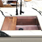 Nantucket Sinks KCH-PS-3220 installed in black-veined marble with the board on the ledge