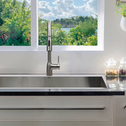 Nantucket Sinks KFPD16BRS brushed stainless faucet over a stainless undermount sink under a window