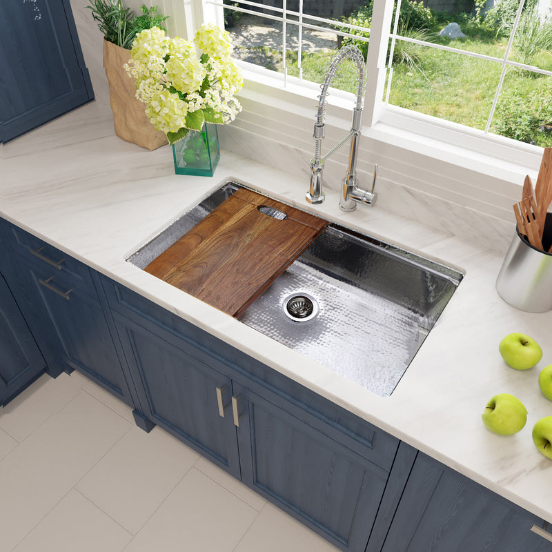 Nantucket Sinks KSSH-PS-3220 installed in a white counter over blue cabinets with the board