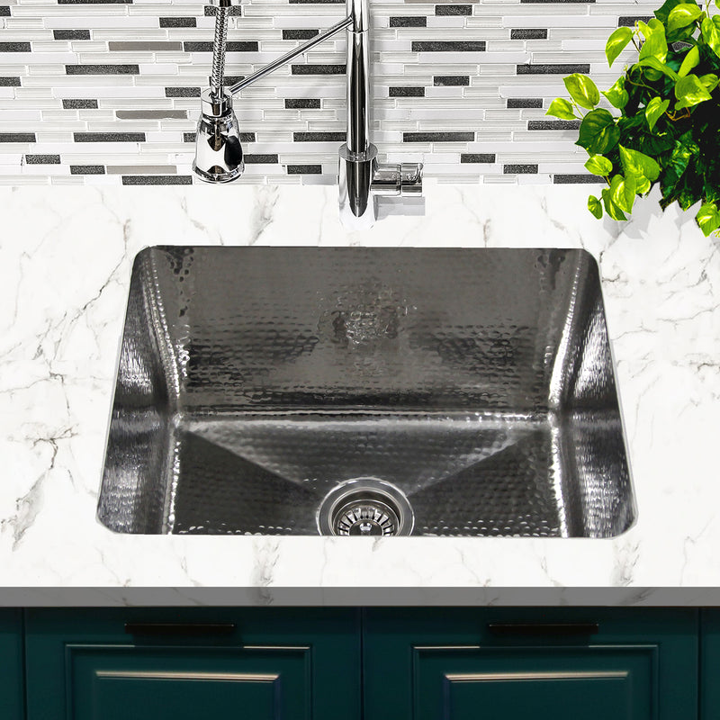 Nantucket Sinks KSSH2318-12 installed in white marble with a chrome faucet over teal cabinets