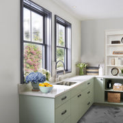 Nantucket Sinks KSSH2318-9 installed in a sage green kitchen corner under twin windows