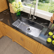 Nantucket Sinks KSSH3219-10 installed in a black counter over wood cabinets with a window