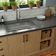 Nantucket Sinks KSSH3219-10 installed in a dark counter with subway tile and herb pots