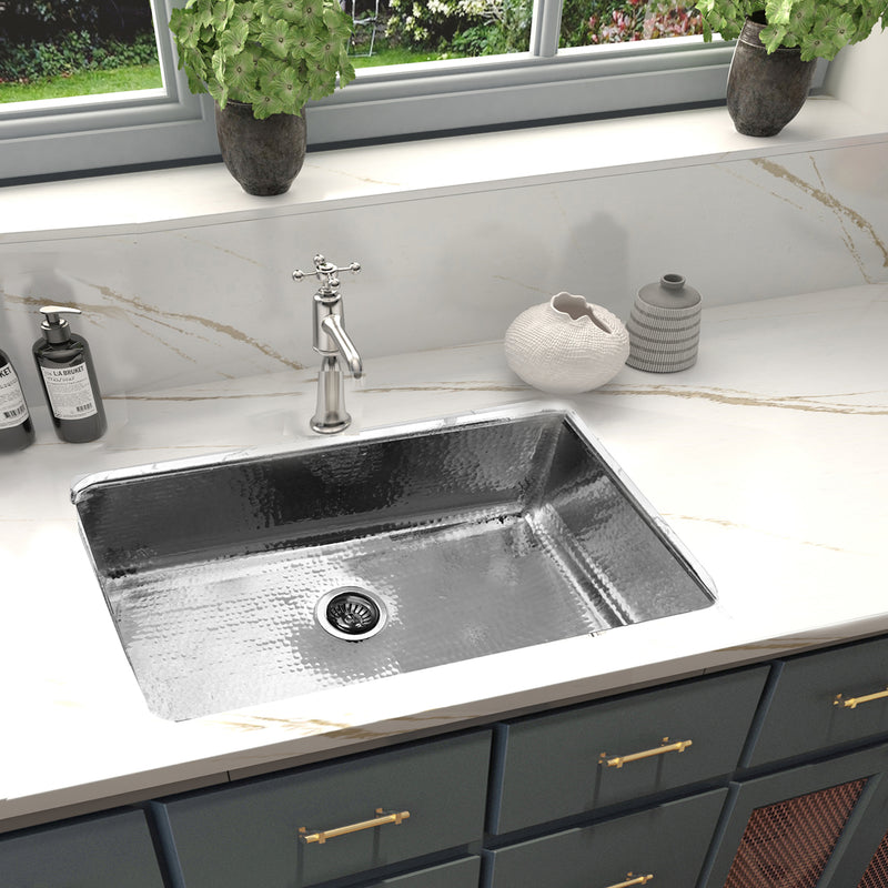Nantucket Sinks KSSH3219-10 installed in a white marble counter with a bridge faucet