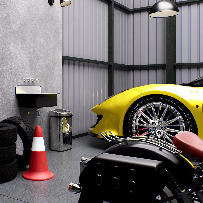 Nantucket Sinks NS-ACBS20-BLKW black bucket sink wall-mounted in a garage beside a motorcycle and sports car