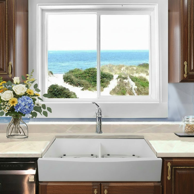 Nantucket Sinks NS-GSEZA32D EZApron farmhouse sink below a window with an ocean view and wood cabinets