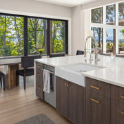 Nantucket Sinks NS-GSEZA32S white EZApron sink in a kitchen island with wood cabinets and window wall
