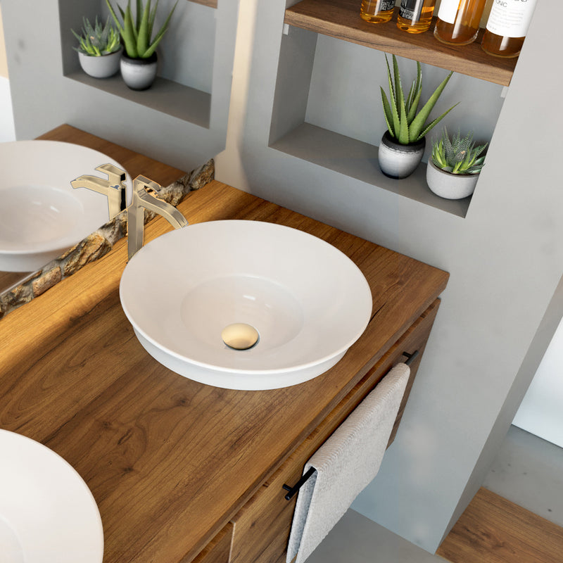 Nantucket Sinks NS-UDBG brushed gold drain in a white round vessel sink on a wood vanity