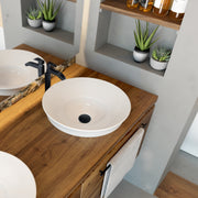 Nantucket Sinks NS-UDMB matte black drain in a white round vessel sink on a wood vanity with black faucet