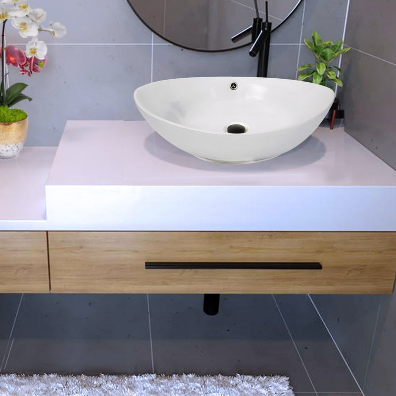 Nantucket Sinks NS-UDMB-OF matte black drain in a white oval vessel sink with overflow hole on a white vanity