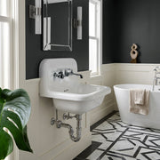 Nantucket Sinks NS-VC16-WW-CPFCT wall-mount sink with chrome faucet and exposed trap in a black and white bathroom