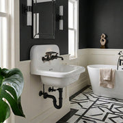 Nantucket Sinks NS-VC16-WW-MBFCT wall-mount sink with matte black faucet and black trap in a black and white bath
