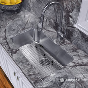 Nantucket Sinks NS3018-9-16 installed in gray stone with grid and pull-down faucet