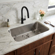 Nantucket Sinks NS3018-9-16 installed in white marble with a black faucet and grid