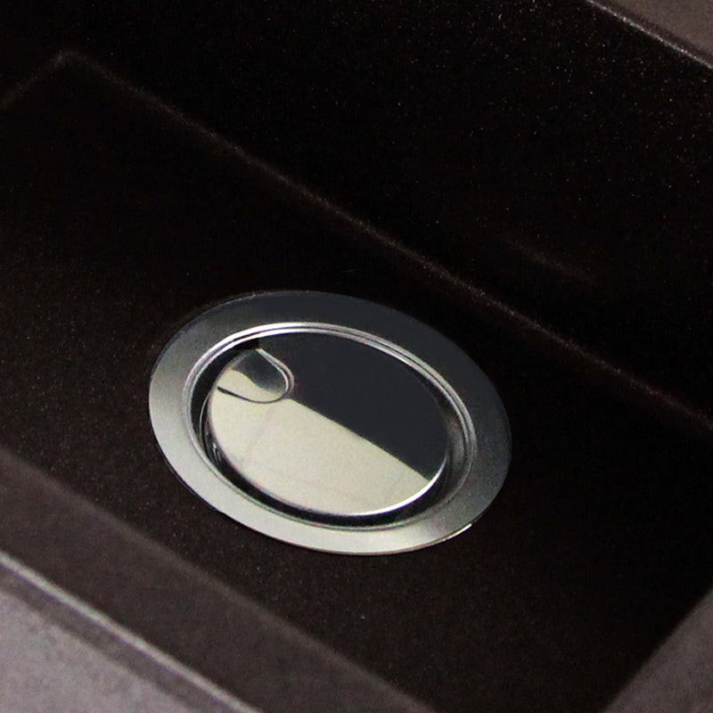 Nantucket Sinks NS35LCC-CH chrome crumb cup drain closed in a dark granite composite sink