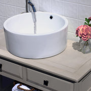 Nantucket Sinks NSV213 white round vessel sink on a gray vanity with a running wall faucet
