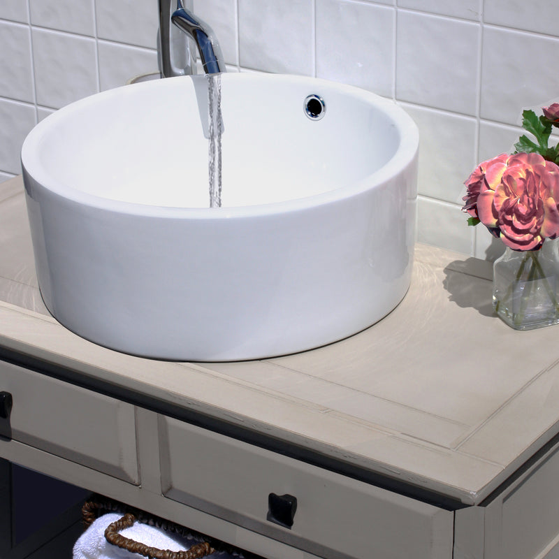 Nantucket Sinks NSV213 white round vessel sink on a gray vanity with a running wall faucet