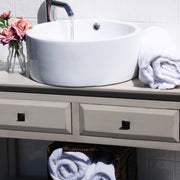 Nantucket Sinks NSV213 white round vessel sink on a gray console vanity with towels