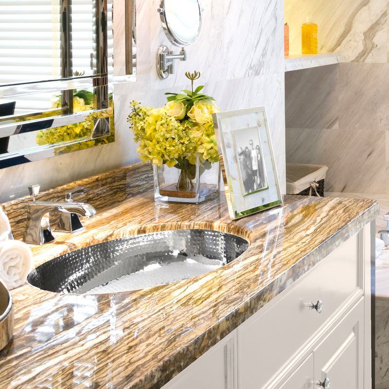 Nantucket Sinks OVS installed in a gold-veined stone vanity with a chrome faucet