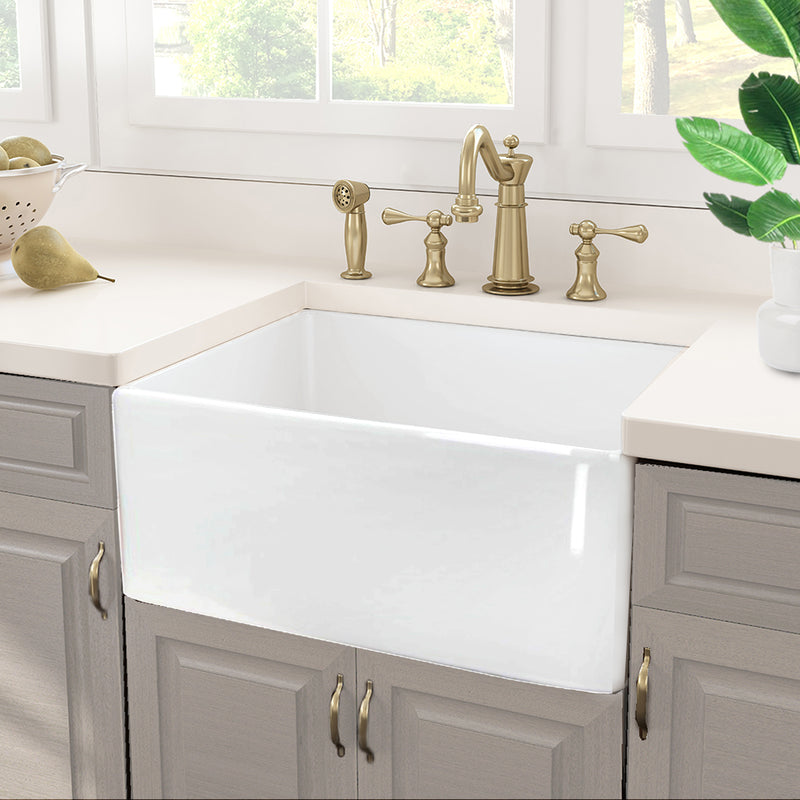 Nantucket Sinks P-FCS23 23" farmhouse sink in grey cabinets with a brass faucet under a window