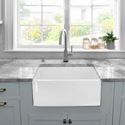 Nantucket Sinks P-FCS23 23" farmhouse sink under grey stone counters by a window