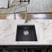 Nantucket Sinks PR1716-BL black bar sink undermounted in a white marble counter with a pull-down faucet