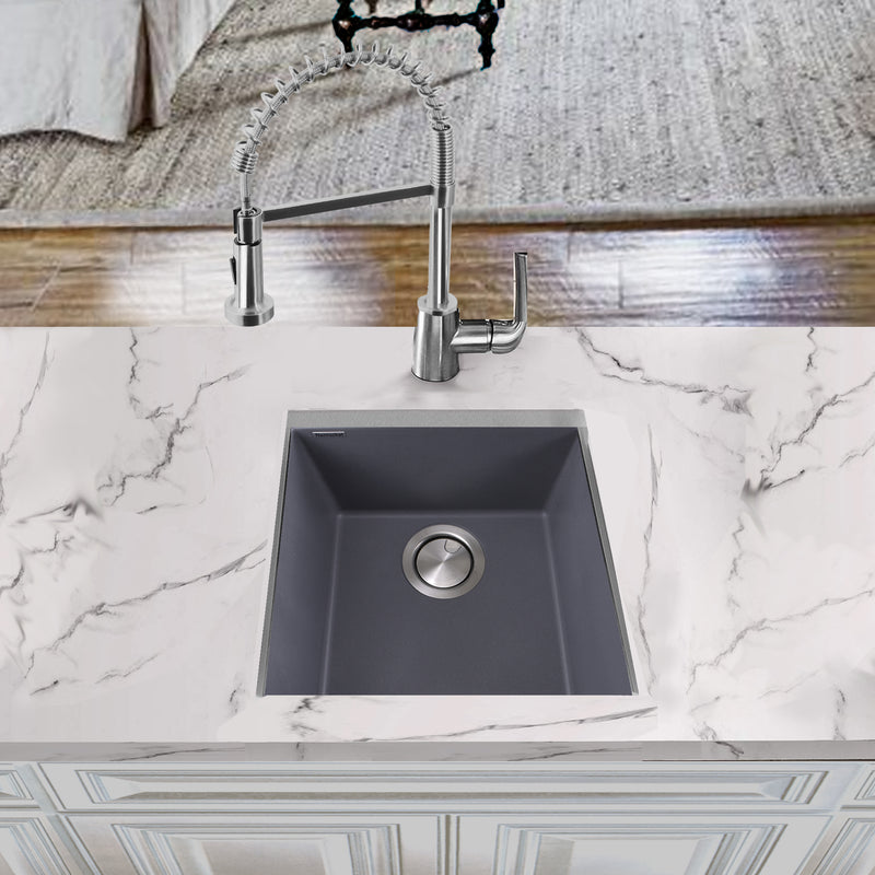Nantucket Sinks PR1716-TI titanium gray bar sink undermounted in a white marble counter with a pull-down faucet