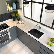 Nantucket Sinks PR2418-BL black sink undermounted in a white marble corner counter