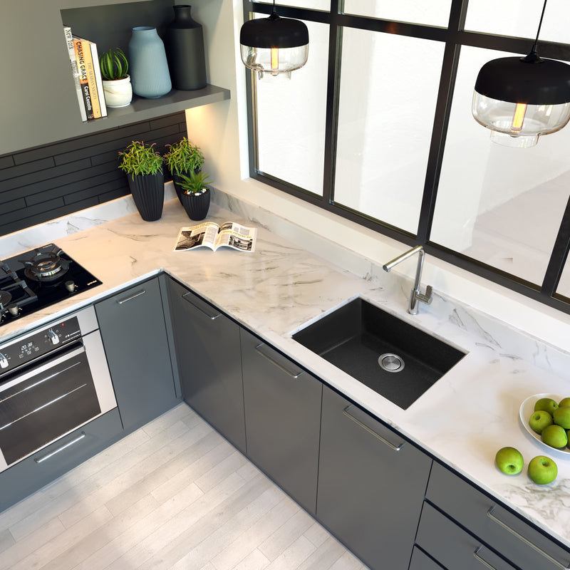 Nantucket Sinks PR2418-BL black sink undermounted in a white marble corner counter