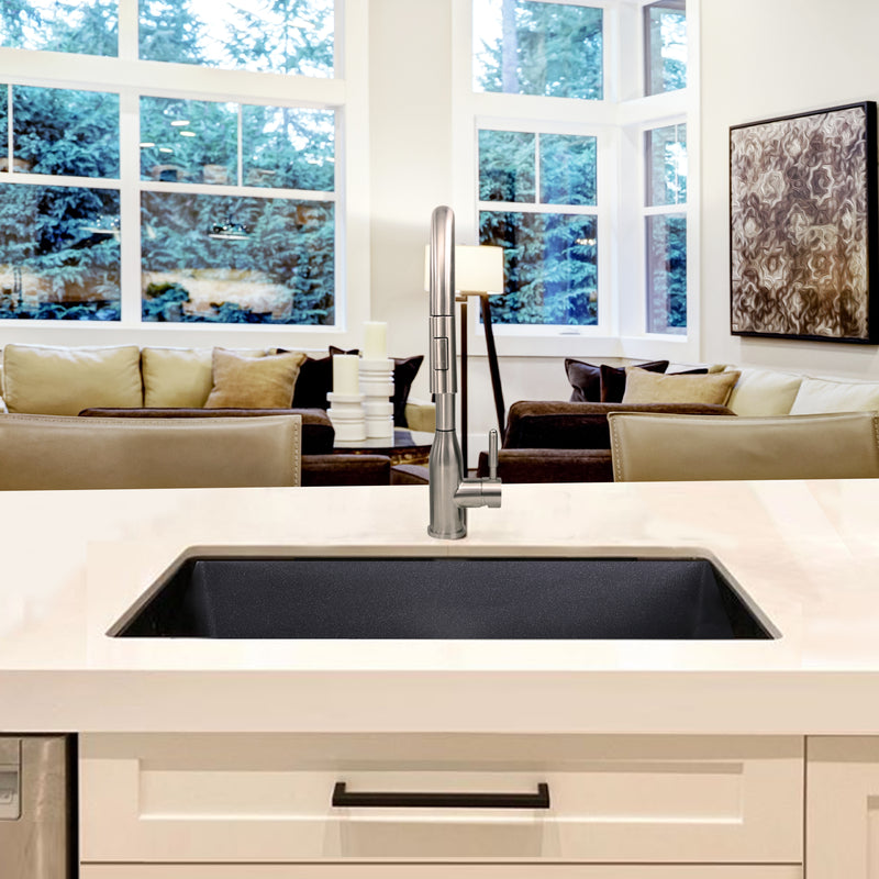 Nantucket Sinks PR2418-BL black sink undermounted in a white kitchen island facing the living room