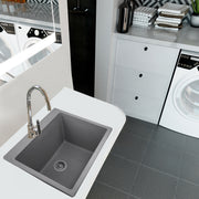 Nantucket Sinks PR2522-DM-TI titanium laundry sink undermounted in a white counter beside a washer