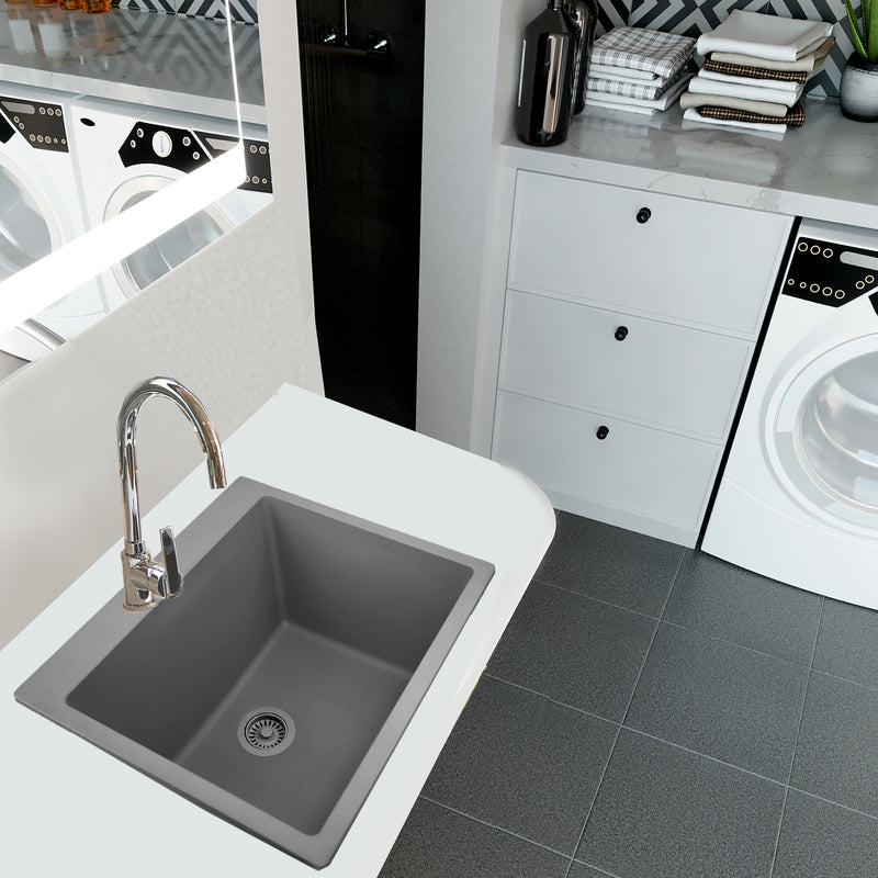 Nantucket Sinks PR2522-DM-TI titanium laundry sink undermounted in a white counter beside a washer