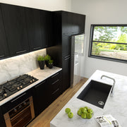 Nantucket Sinks PR3018-BL black single-bowl sink undermounted in a marble kitchen island