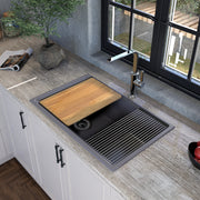 Nantucket Sinks PR3019PS-TI titanium workstation sink in a stone counter with cutting board and mat