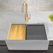 Nantucket Sinks PR3020-APS-G light grey apron workstation sink in a marble counter with a brass faucet