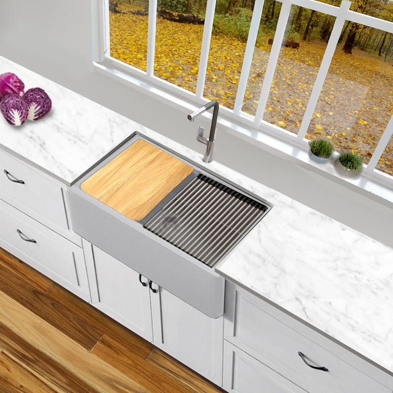 Nantucket Sinks PR3020-APS-G light grey apron sink with cutting board and mat in a white kitchen under a window