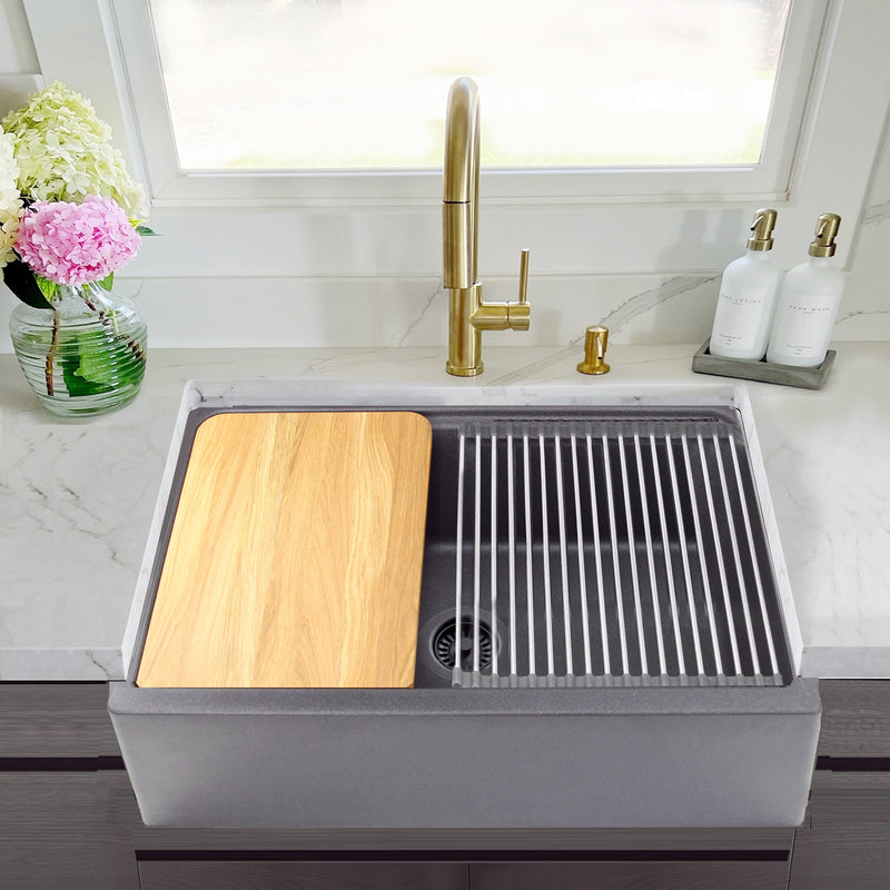 Nantucket Sinks PR3020-APS-TI titanium apron workstation sink in a marble counter with a brass faucet