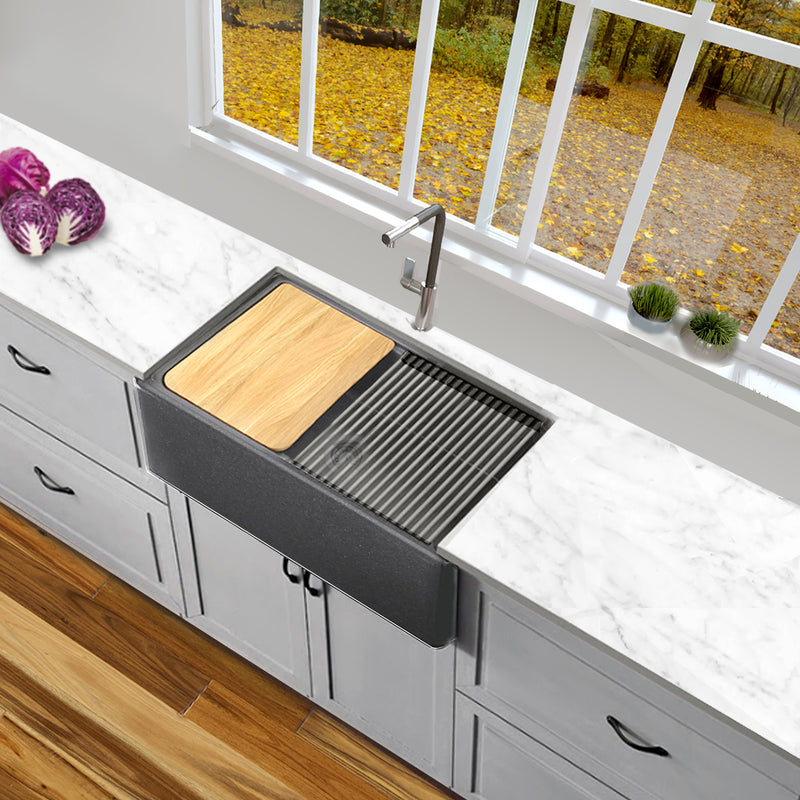 Nantucket Sinks PR3020-APS-TI titanium apron sink with cutting board and mat in a white kitchen under a window