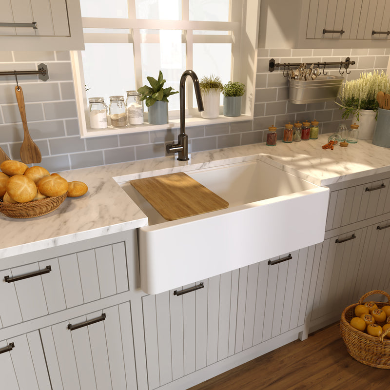 Nantucket Sinks PR3320-APS-W white apron workstation sink in a marble counter with a cutting board