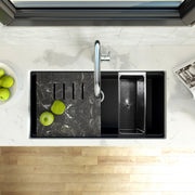Nantucket Sinks PR3419-NBL-UM black workstation sink in a marble counter seen from above with board and colander