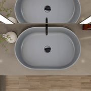 Nantucket Sinks RC5022C Matte Concrete oval vessel sink from above on a grey counter with black faucet