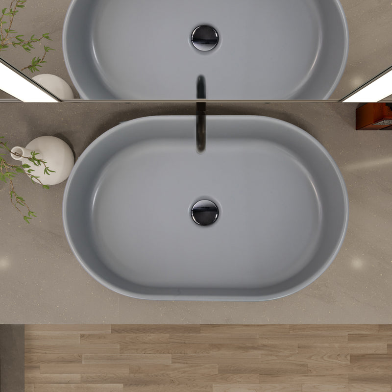 Nantucket Sinks RC5022C Matte Concrete oval vessel sink from above on a grey counter with black faucet