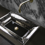 Nantucket Sinks RC73040PR Porto Cervo sink on a dark counter under a wall spout with marble backsplash