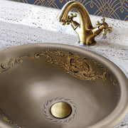 Nantucket Sinks RC73240BHY St. Louis drop-in sink in a stone counter with an antique brass faucet