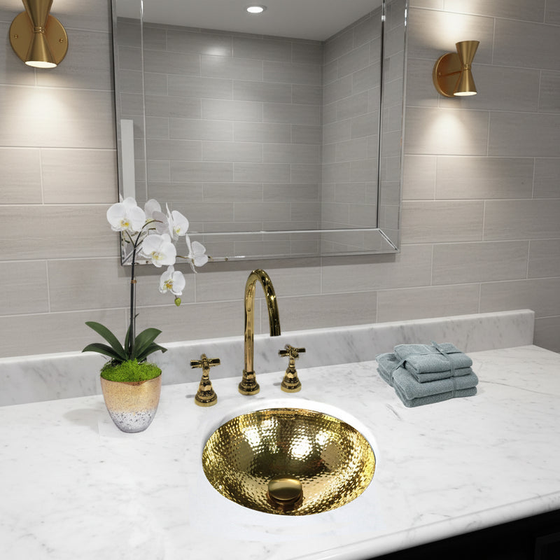 Nantucket Sinks ROB-OF round hammered brass sink in a white marble vanity with a brass faucet