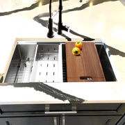 Nantucket Sinks SR-PS-3219-DE-16 installed in white marble with colander, board and black faucet
