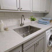 Nantucket Sinks SR2318-12-16 installed in a white laundry counter beside a washer