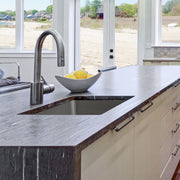 Nantucket Sinks SR2318-16 installed in a dark stone island with a bar faucet