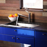 Nantucket Sinks SR3018 installed in dark granite over blue cabinets with water running